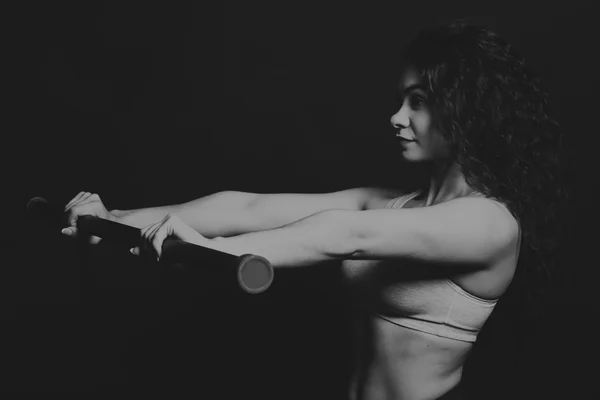 The beautiful sports girl on a dark background — Stock Photo, Image