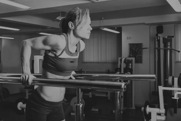 Hermosa chica toma ejercicios en el gimnasio —  Fotos de Stock