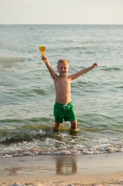 Sahilde kumda oynayan genç bir çocuk
