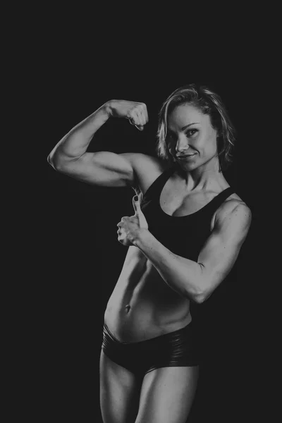 The beautiful sports girl on a dark background — Stock Photo, Image