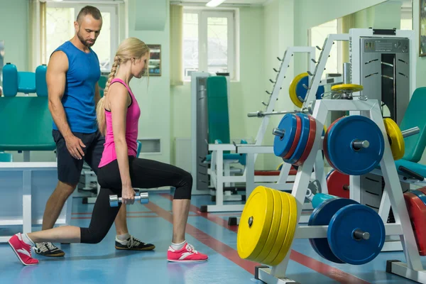 Young couple in the gym at the joint training — Stock Photo, Image