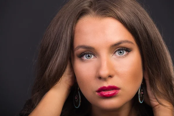 Beautiful brunette in a dark dress — Stock Photo, Image