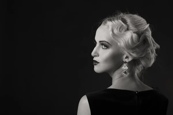 Beautiful blonde in vintage dress on a dark background — Stock Photo, Image