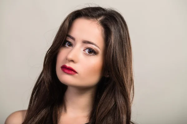 Beautiful brunette in a dark dress — Stock Photo, Image