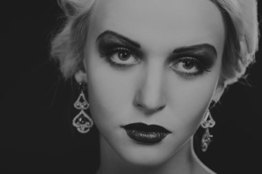 Güzel sarışın güzel takı üzerinde karanlık bir arka plan ile. Şık elbise ve aksesuarlar. Güzel bir siyah beyaz fotoğraf şık kız. Moda dergileri, afiş ve Web siteleri için fotoğraf.