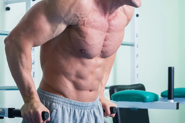 Starker muskulöser Mann bei Übungen im Fitnessstudio. — Stockfoto