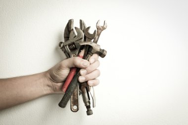 Hand of male holding old tools