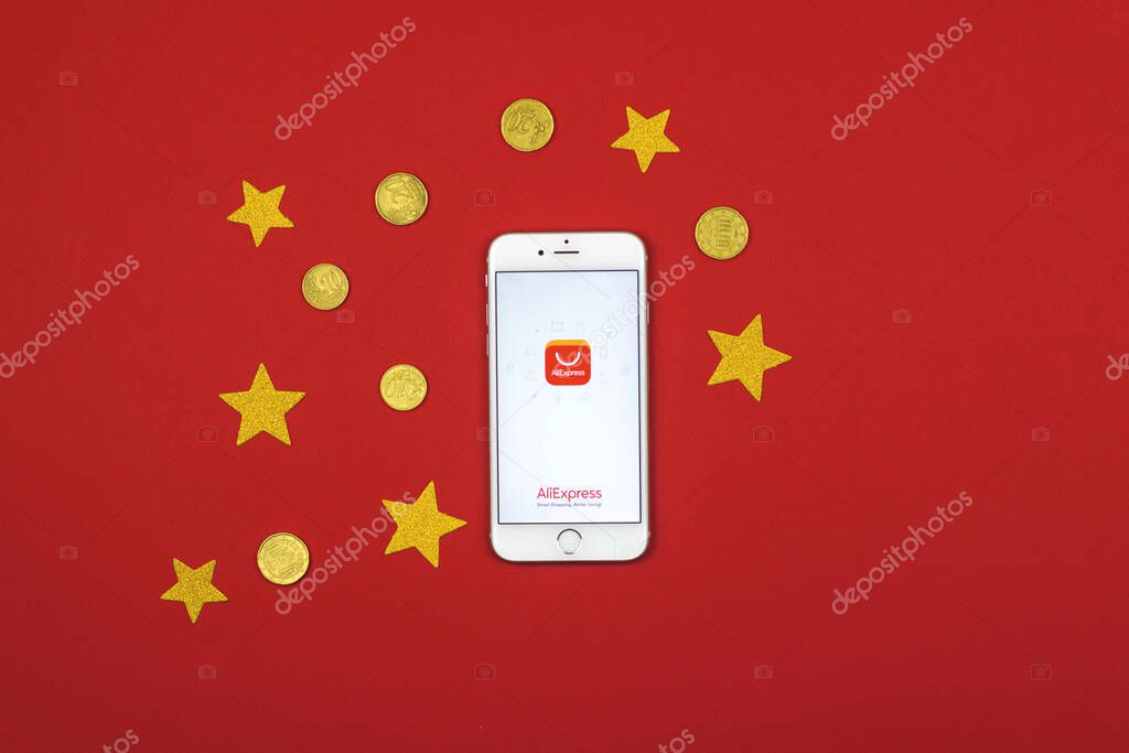 Kharkov, Ukraine - February 5, 2021: Aliexpress application icon and logo on Apple smartphone screen, creative flat lay background of Chine online store photo