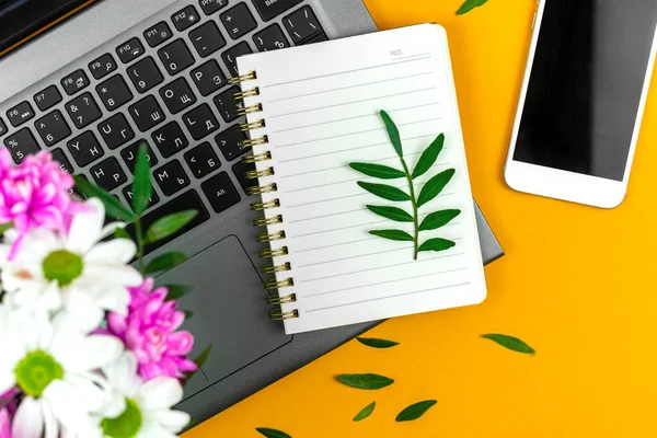 Spring mockup with blank notepad, office desktop with bouquet of flowers, holiday background photo