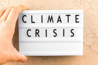Climate crisis text message, climate changes concept background with letters on lightbox