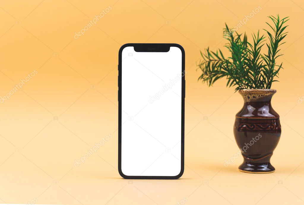 Kharkov, Ukraine - March 26, 2021: Apple iPhone 12 mini with white screen, flat lay mockup concnept, workspace background photo