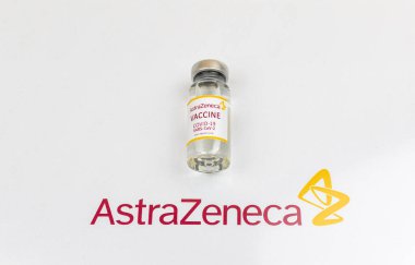 Kharkov, Ukraine - April 18, 2021: Astrazeneca vaccination background, COVID-19 vaccine vial with logo on white glass table