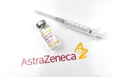 Kharkov, Ukraine - April 18, 2021: Astrazeneca vaccicne vial with logo and medical syringe, vaccination concept background photo
