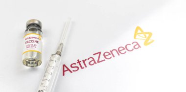 Kharkov, Ukraine - April 18, 2021: Vaccination by Astrazeneca Oxford vaccine, vaccine vial with syringe and logo of company, immunization concept photo