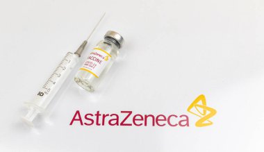 Kharkov, Ukraine - April 18, 2021: Immunization against COVID-19 by using Astra Zeneca vaccine vial, vaccination concept photo