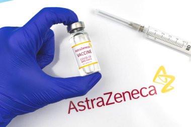 Kharkov, Ukraine - April 18, 2021: Astrazeneca COVID-19 vaccination, vaccine vial in hand of doctor, immunization concept photo