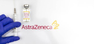 Kharkov, Ukraine - April 18, 2021: Doctor use AstraZeneca COVID-19 vaccine with syringe, vaccination concept banner photo