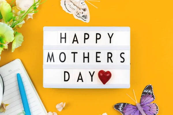 Happy Mothers Day card concept with text message, text inscription, flat lay, top view, love background with flowers and butterfly