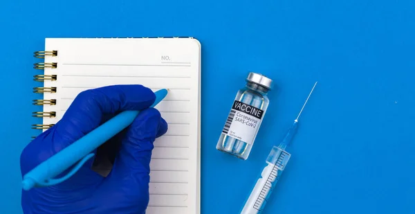 Vaccination healthcare and medicine background with doctor hand and vaccine vial, hospital or laboratory concept photo