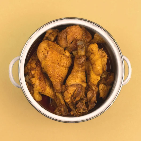 Ready chicken in a saucepan on a colorbackground, the concept of a meal for the whole family, dish top view photo