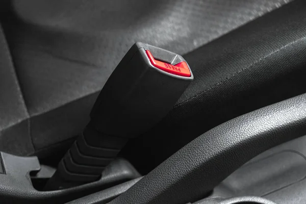 Driver seat belt in the modern black interior car with black seats, concept of the safety