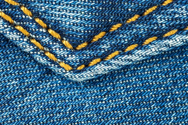 Niebieskie dżinsy z kieszonkowym szwem zbliżenie strzał tło z teksturą tekstyliów — Zdjęcie stockowe