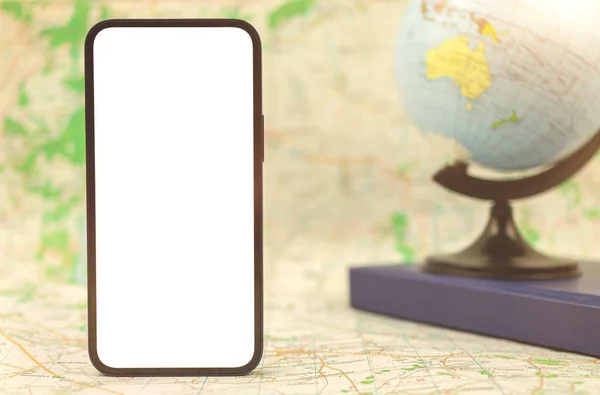 Modern mobile phone with blank white screen on background of the globe and city map, copy space