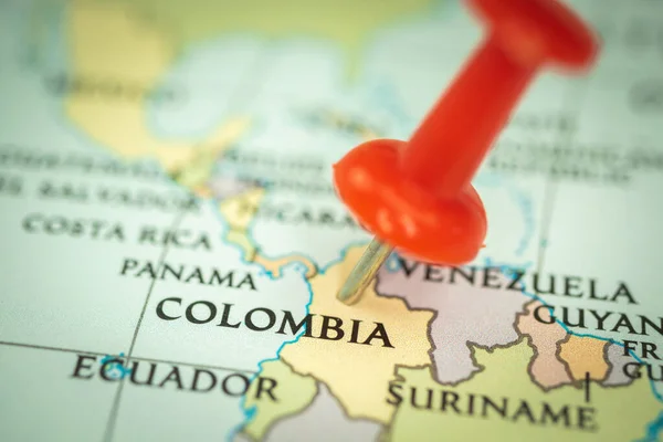 Location Colombia, red push pin on the travel map, marker and point closeup, tourism and trip concept, South America