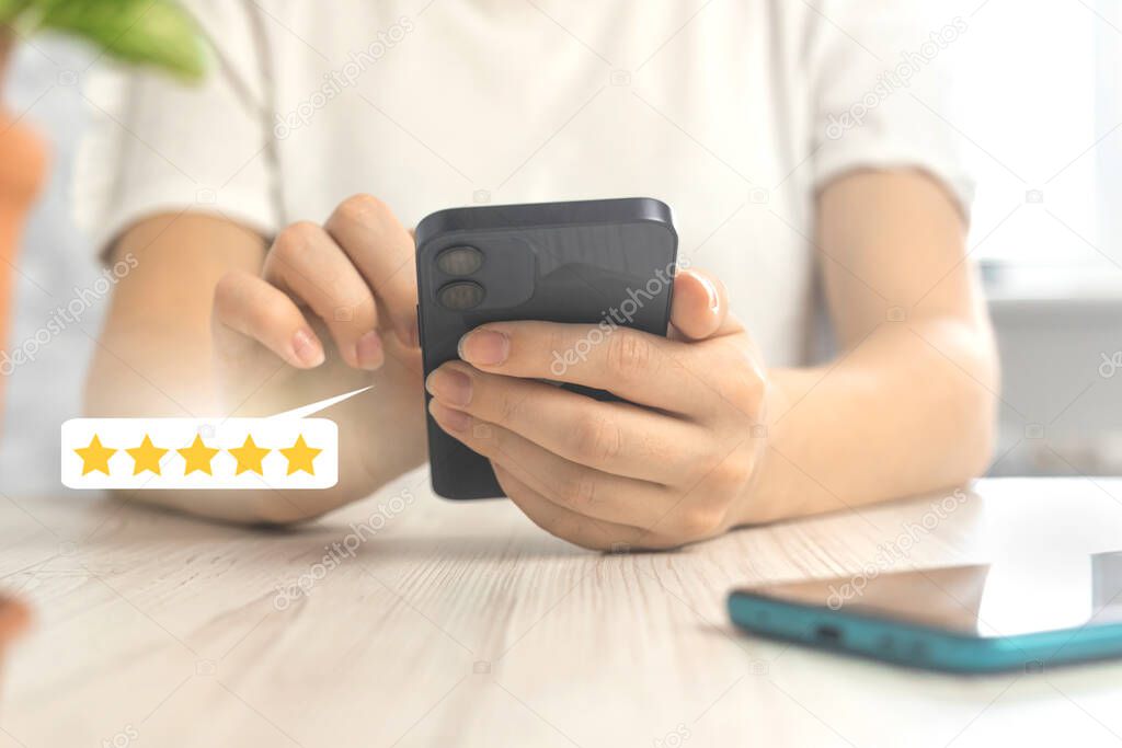 Costumer reviews concept with rating or feedback icon, gold five star review service, woman with smartphone 