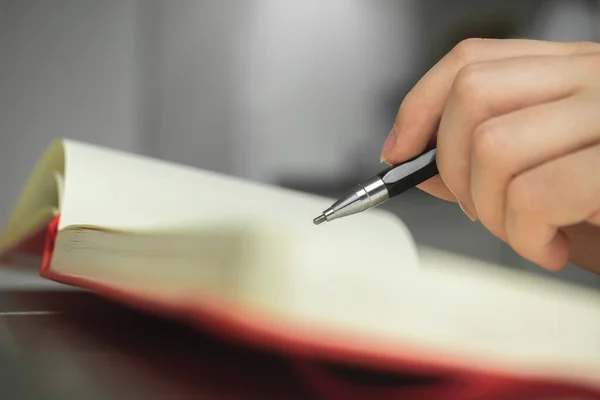 Woman hand with pencil and notebook close-up, artist drawing a pencil sketch art, hobby and creative designer background