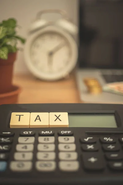 Tax calculating background. Desk calculator, alarm clock and laptop. Financial