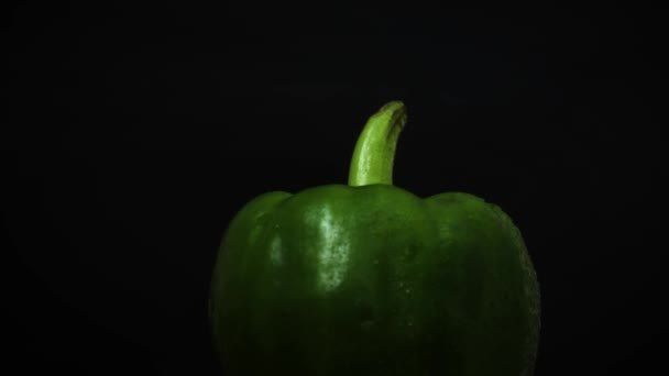 Green Paprika Water Drops Rotating Black Background — Stock Video