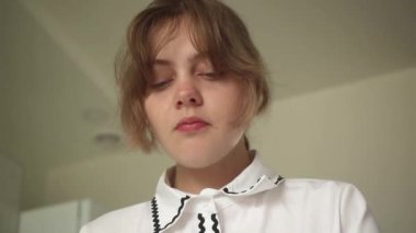 Genç kadın lezzetli yemekler yiyerek ve kameraya gülümseyerek bakarak eğleniyor.