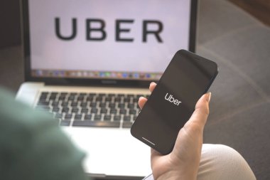 Kharkov, Ukrayna - 23 Ağustos 2021: Cep telefonu ekranında Uber uygulama logosu. Uber uygulama fotoğrafı kullanan kadın