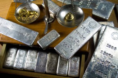 Homestake Mining Company silver bullion bars. Now closed mine located at Lead, South Dakota - Black Hills, USA. Gold bar and raw nuggets on antique balance scale. clipart