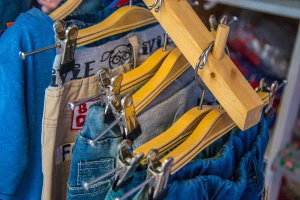 Colorful blouse hanging on clothesline in a shop. — Stock Photo, Image