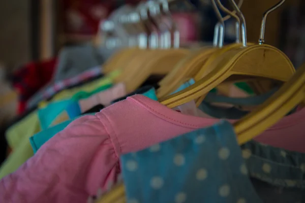 Colorful blouse hanging on clothesline in a shop. — Stock Photo, Image