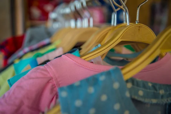 Colorful blouse hanging on clothesline in a shop. — Stock Photo, Image