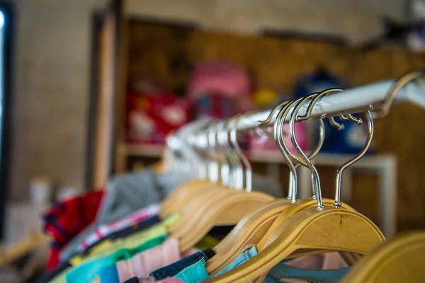 Colorful blouse hanging on clothesline in a shop. — Stock Photo, Image