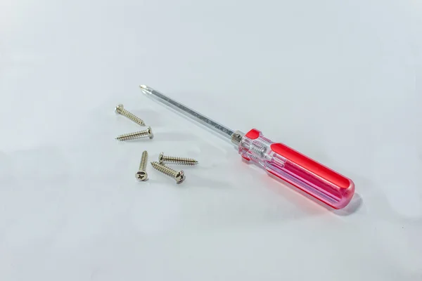 Screwdriver and screws on a white background. — Stock Photo, Image