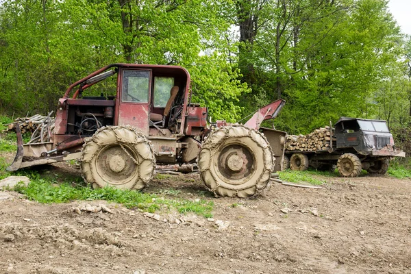 Bulldozer and old truck in a forest — Stock Photo, Image