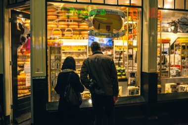 Back view of people neear cheese shop