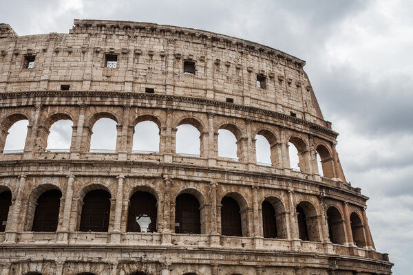 Colosseum against cloudy sky in Rome, Italy