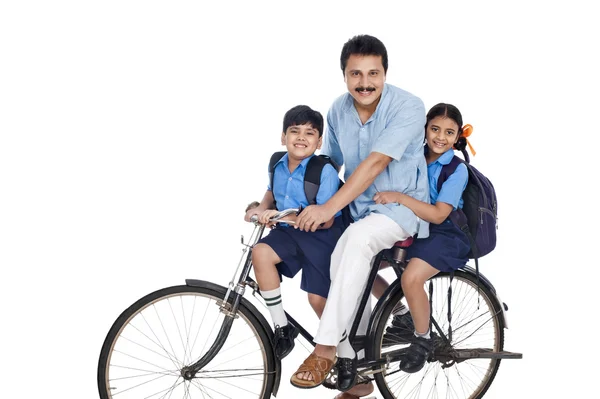 Homem com seus filhos em uma bicicleta — Fotografia de Stock