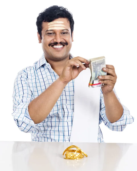 Portrait of a South Indian man counting money and smiling — Stock Photo, Image