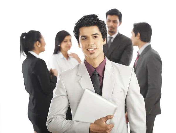 Portrait of a businessman smiling with his colleagues in the bac — Stock Photo, Image