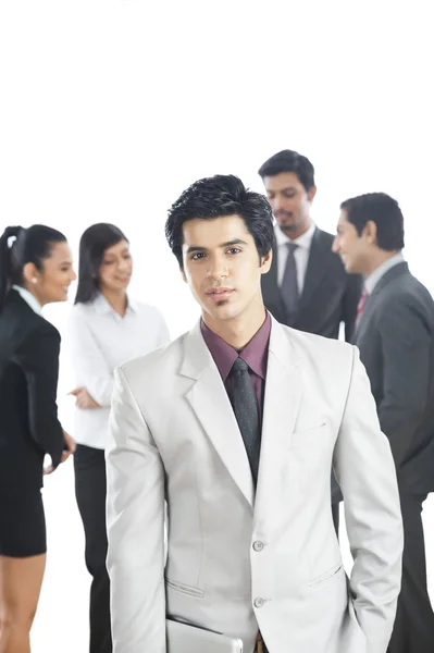 Portrait of a businessman with his colleagues in the background — Stock Photo, Image