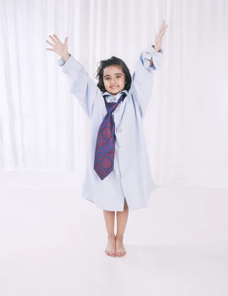 Portrait of a smiling girl wearing oversize shirt with tie — Stock Photo, Image