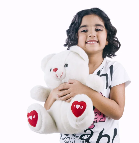 Portrait of a girl holding a teddy bear and smiling — Stock Photo, Image