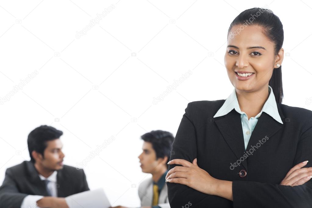 Portrait of a businesswoman smiling with her colleagues in the b